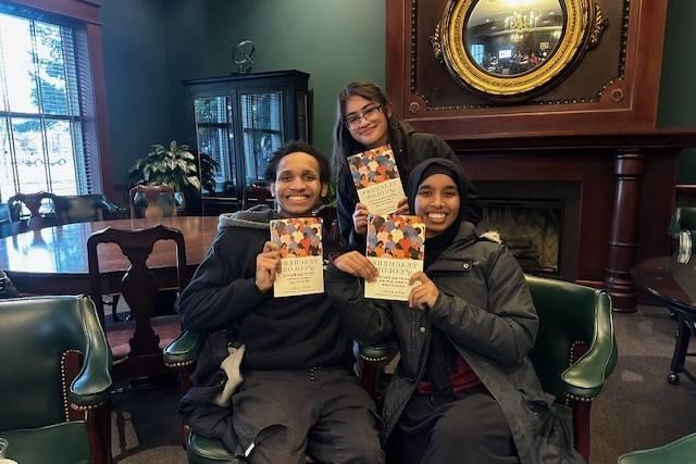 Group of Educators of Color Network students holding up books